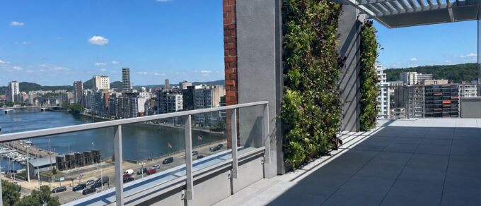 Roof terrace on the 11th floor with two MobiPanel living walls against the pillars and views over the River Meuse and the Liège skyline
