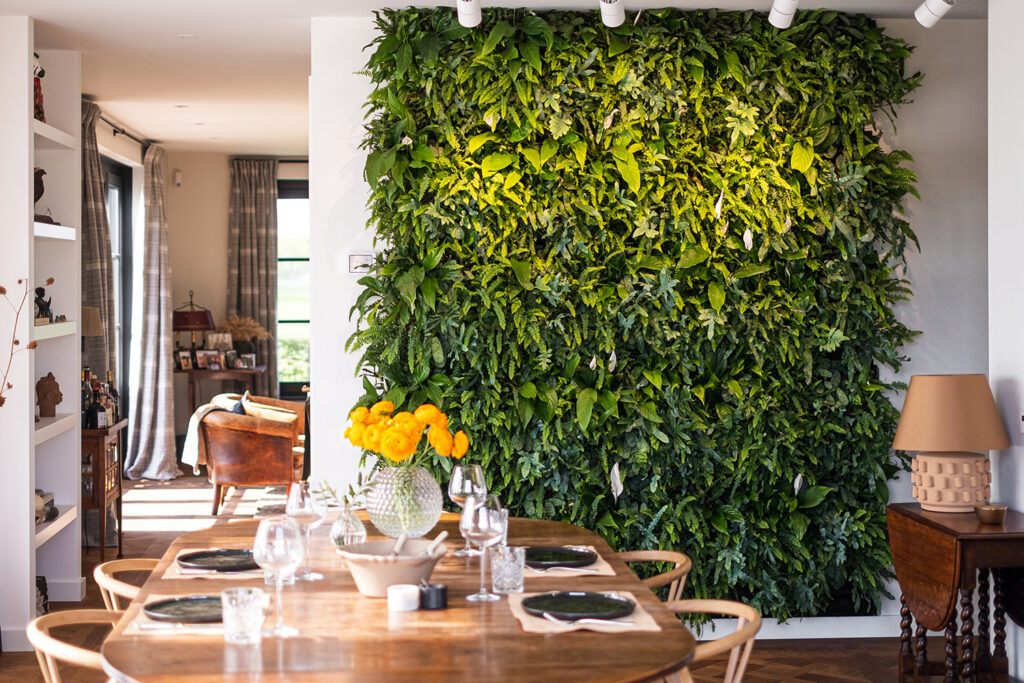 Green living wall in a modern office, contributing to air quality and employee wellbeing